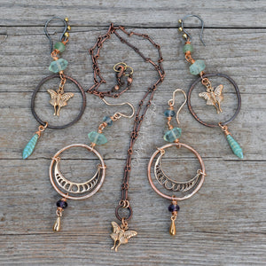 Jewelry set with earrings and a necklace on a wooden surface