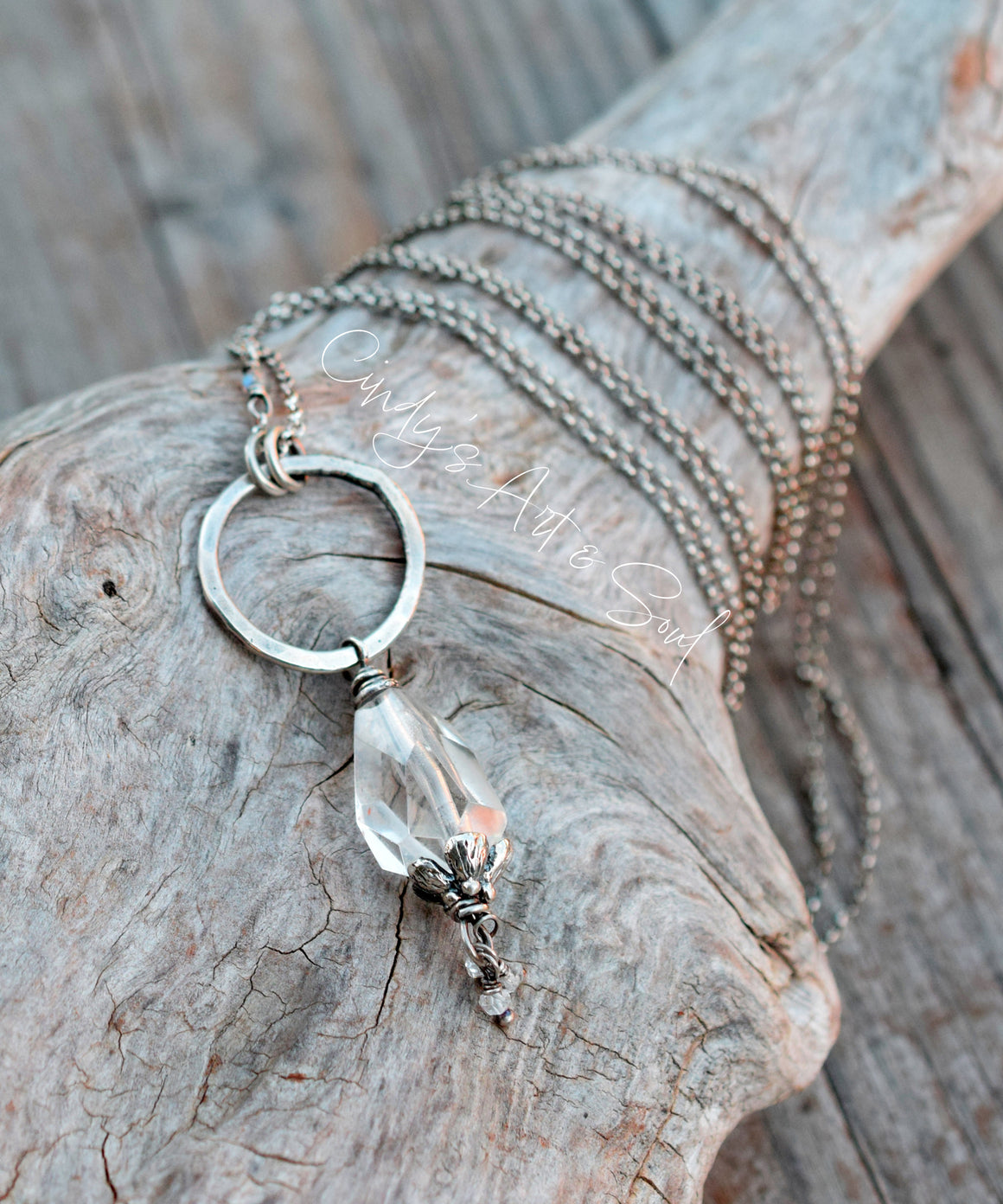 Necklace with a clear pendant on a wooden surface