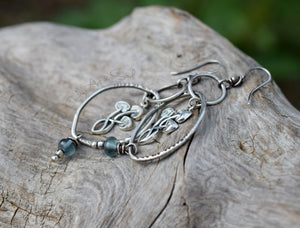 Silver earrings with blue beads on a wooden surface