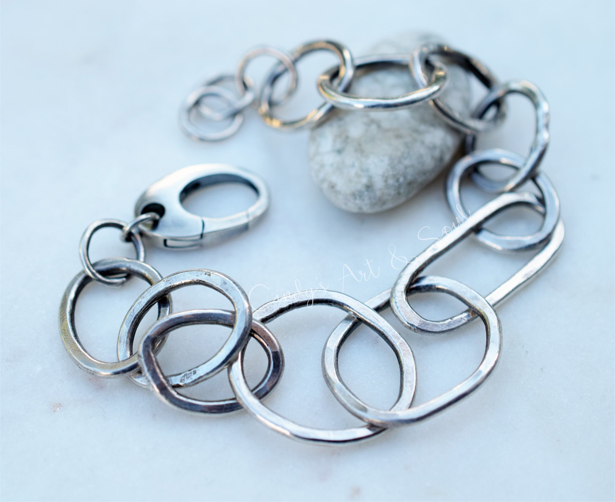 Silver chain bracelet on a light background
