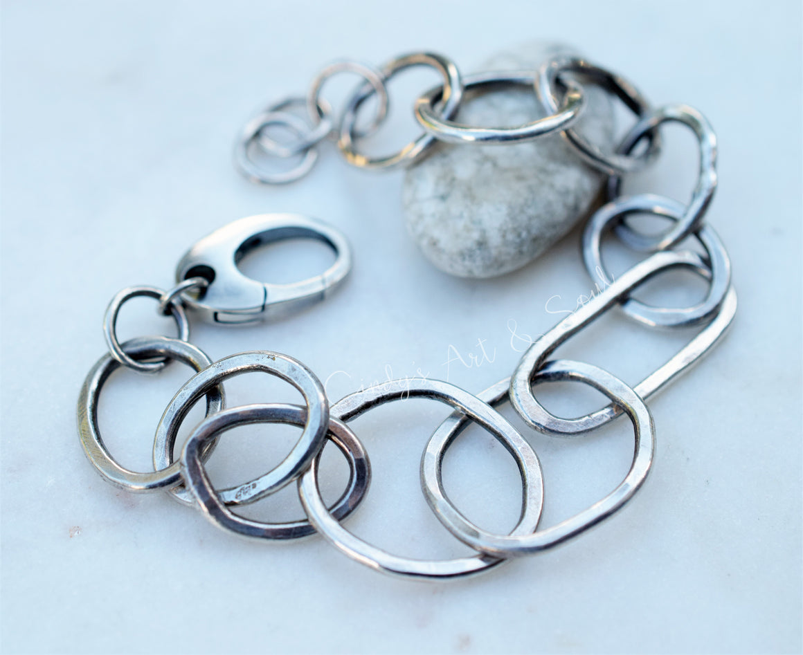 Silver chain bracelet on a light background