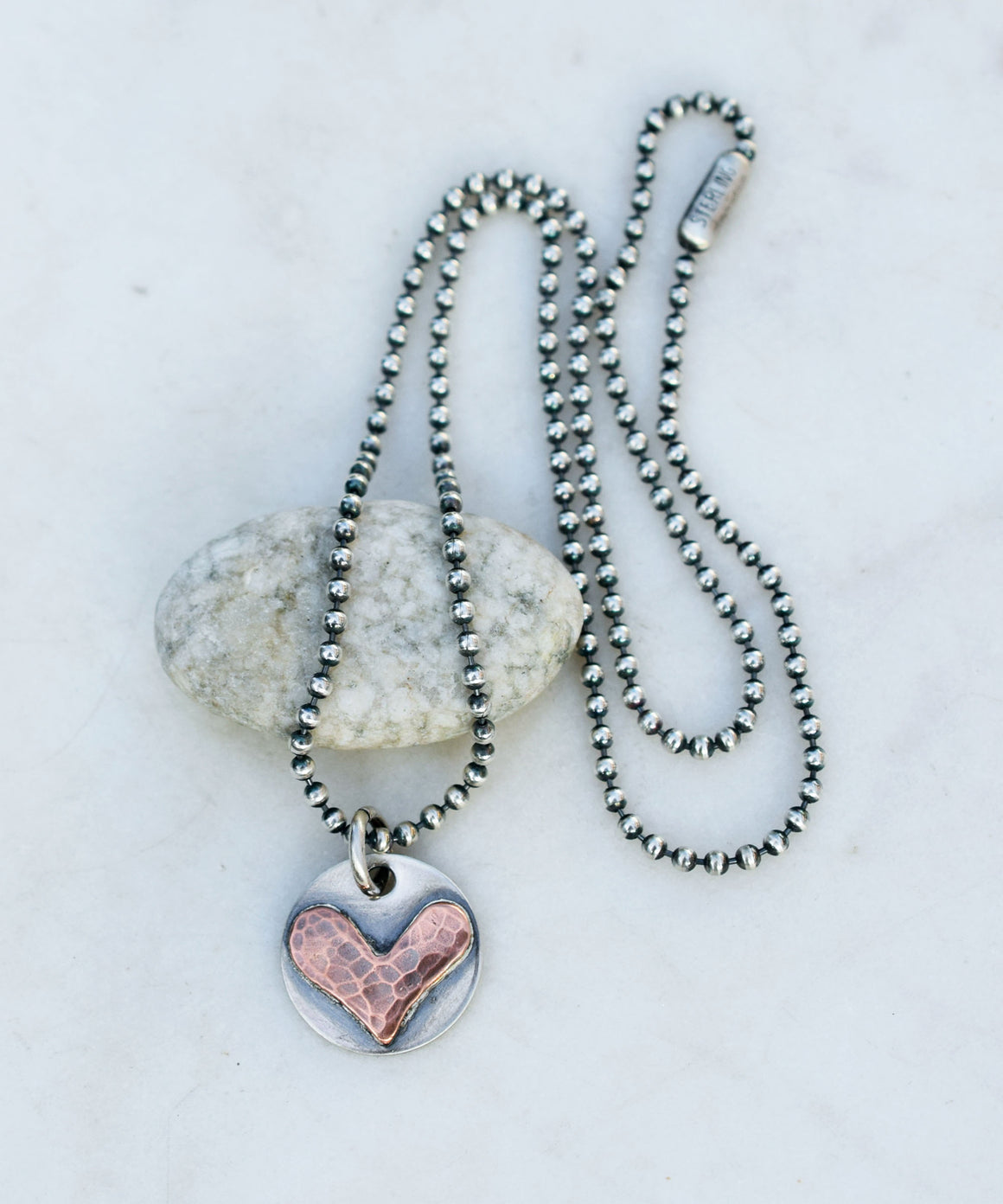 Necklace with a heart-shaped pendant on a white background