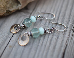 Bohemain style earrings made with blue gemstones and golden brass dangles.
