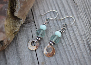 Bohemain style earrings made with blue gemstones and golden brass dangles.