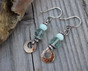 Bohemain style earrings made with blue gemstones and golden brass dangles.