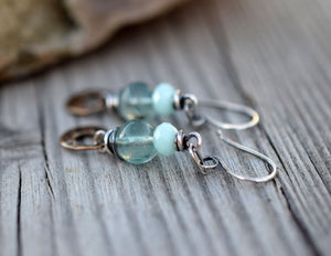 Bohemain style earrings made with blue gemstones and golden brass dangles.