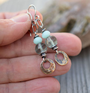 Bohemain style earrings made with blue gemstones and golden brass dangles.