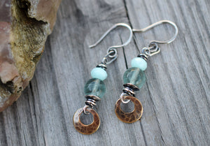 Bohemain style earrings made with blue gemstones and golden brass dangles.