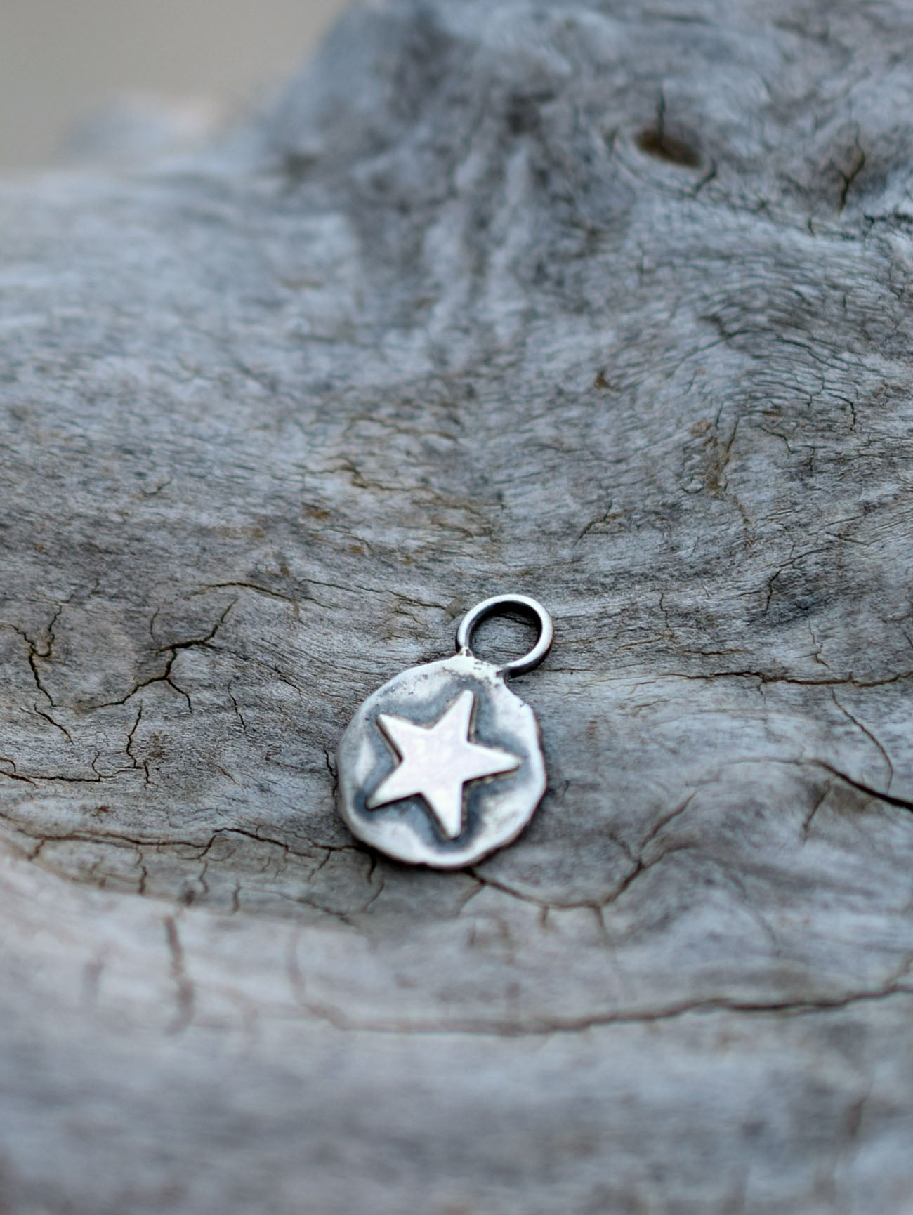 silver star charm on a wood background